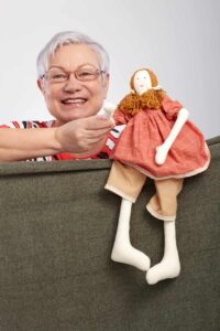 Elderly lady playing puppet show | Catalyst Center
