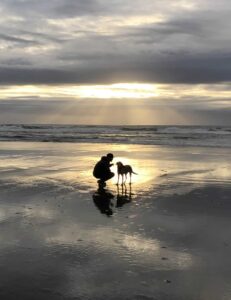 picture of man and beloved pup in warm sunlight symbolizing Pet Loss and grief