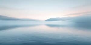 Sunrise Over Calm Water | Catalyst Center Sunrise over calm water with soft golden and pink reflections, symbolizing emotional healing, depression therapy, hope, and the start of a new day.