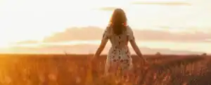 woman in golden field of wheat