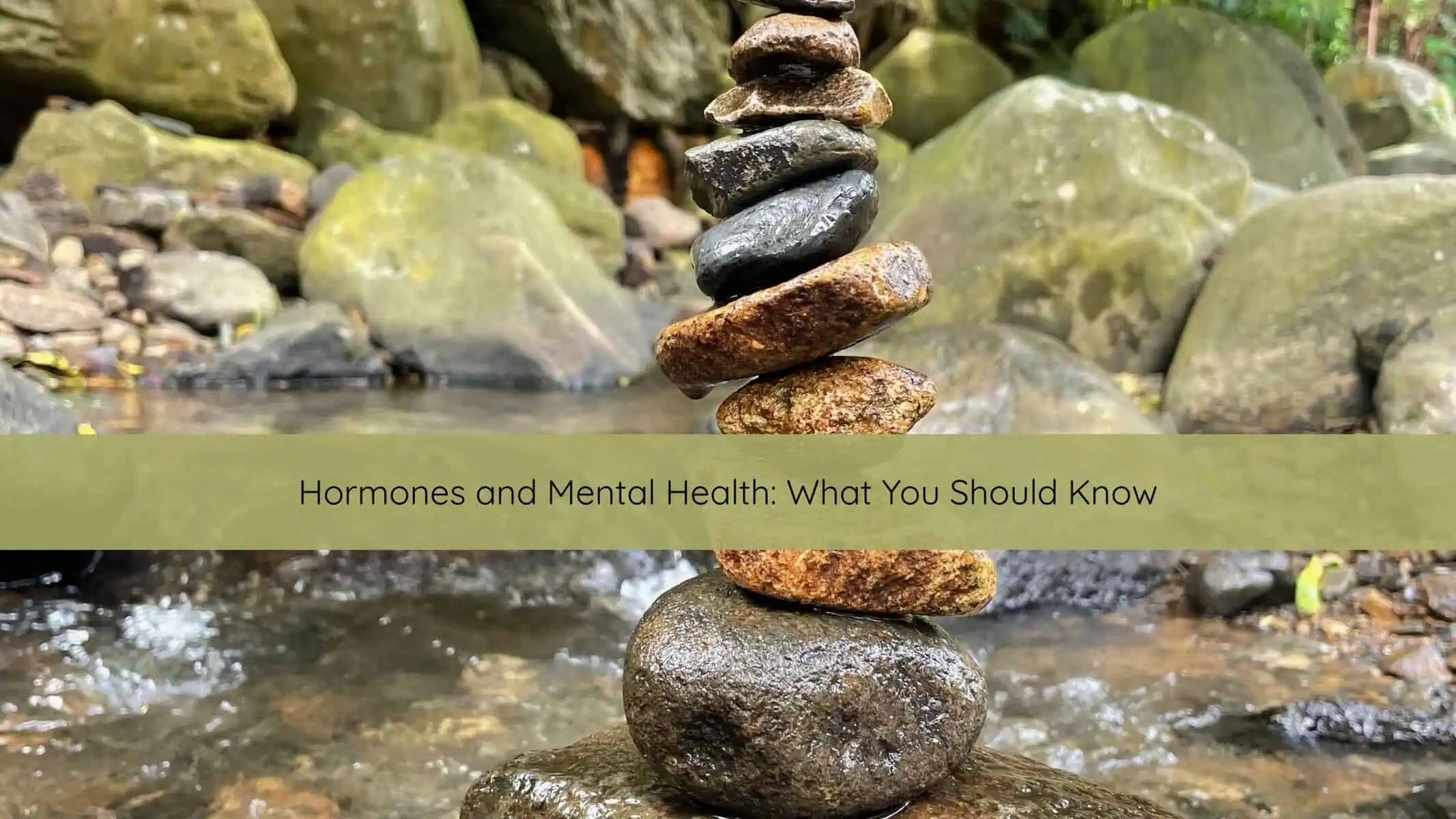Calm scene with rocks balanced near water symbolizing balance and resilience through hormonal changes.