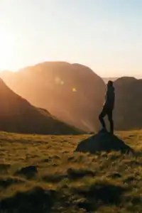 man in nature standing in sunbeams