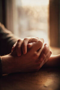 Couple holding hands in therapy, finding hope and reconnection after trauma in Denver couples intensive.