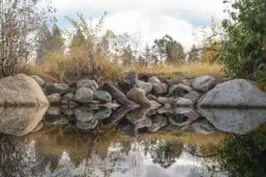 tucker-riggins-tusGZQNLgyU-unsplash | Catalyst Center Still lake reflecting clouds and sky, symbolizing reflection and emotional openness in relationships.