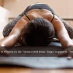 Person practicing calming yoga pose symbolizing grounding and becoming resourced.