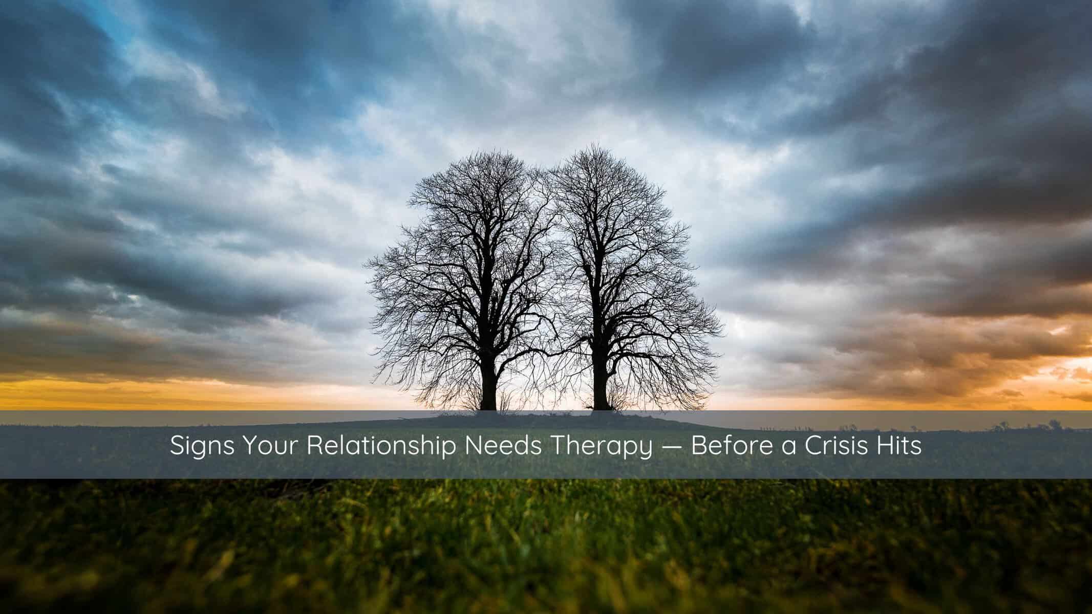 Two trees growing side by side with intertwining branches, symbolizing partnership and connection