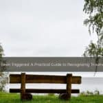 Signs Youve Been Triggered A Practical Guide to Recognizing Trauma Symptoms | Catalyst Center Empty wooden bench in a quiet park setting representing emotional withdrawal as a trauma response