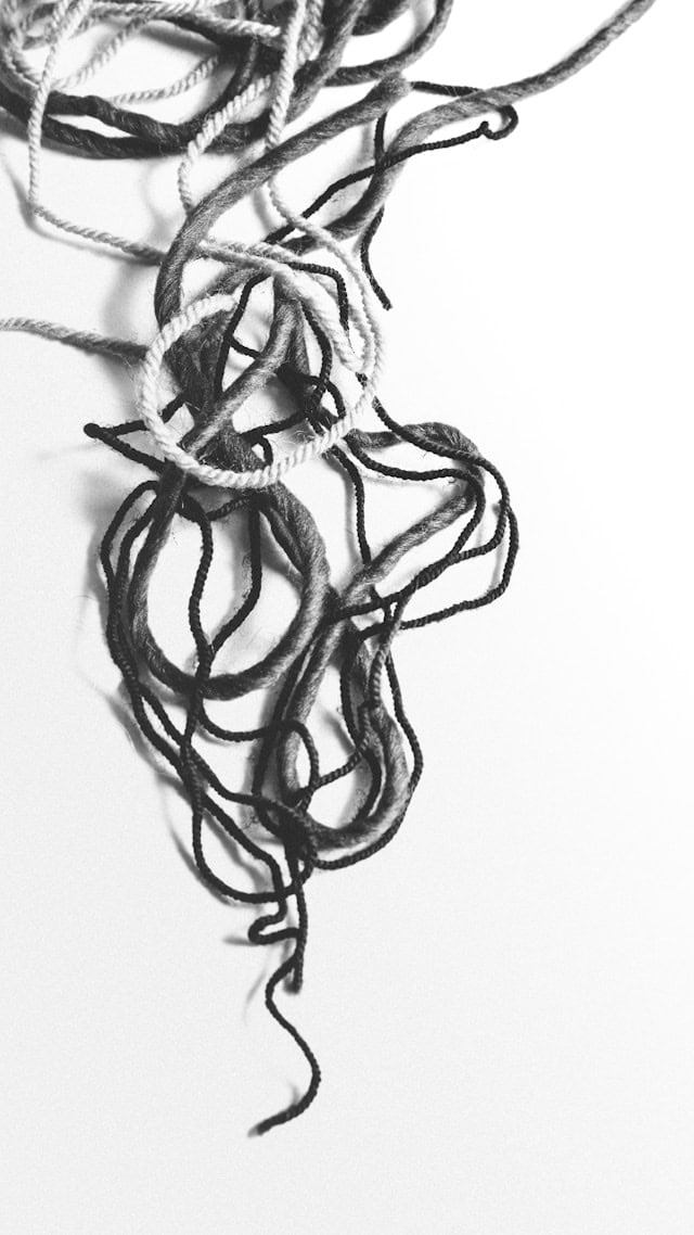 Tangled cords on a light background representing the complex patterns of trauma responses in the nervous system