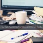 A cluttered desk with an open planner, handwritten sticky notes, and a cup of tea in soft natural light