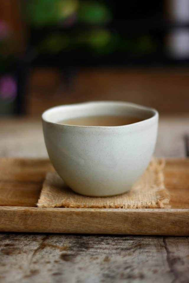 An empty ceramic bowl on a wooden surface, representing openness and the zen concept of emptiness