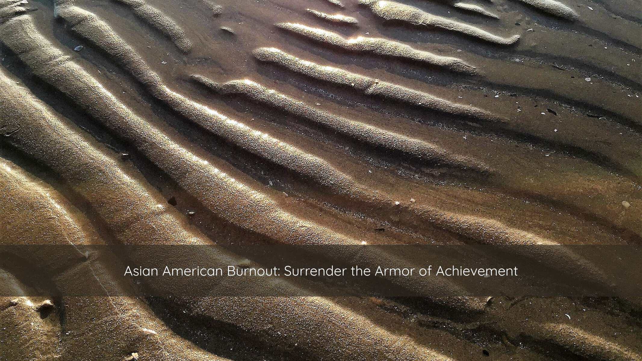Rippled sand at low tide in soft morning light, evoking the quiet exhaustion of Asian American burnout